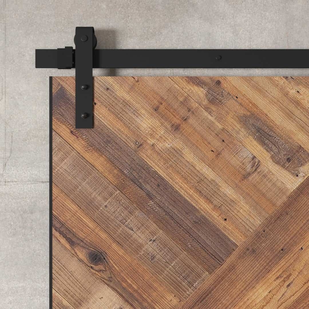 Urban-Woodcraft-Malibu-Barn-Door-Natural-4.jpg Close-up of the Malibu Barn Door, featuring a wooden sliding design with a sleek black metal track and mounting hardware, set against a concrete wall.