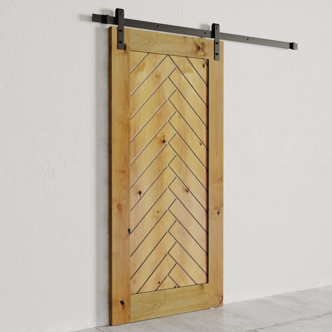 The Nuvo Barn Door, featuring a chevron pattern design, stands partially open against a white wall. It is mounted on a black metal rail.