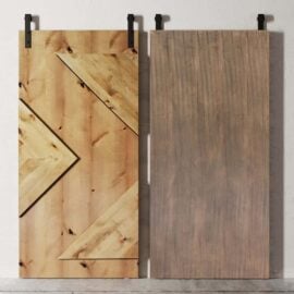 Two Raised Arrow Head Barn Doors; the left door features a geometric design with visible grain patterns while the right door has a plain, uniform wood texture. Both doors are mounted on black rail hardware.