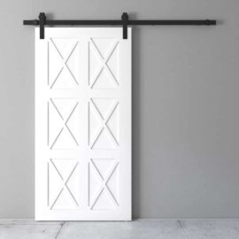 An Oxford Barn Door featuring a white, cross-pattern design is installed on a gray wall with black metal hardware.