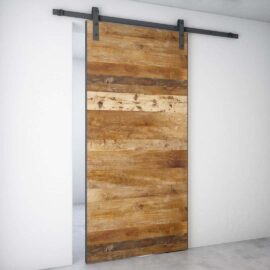 The Maison Barn Door, featuring horizontal wooden planks and a metal track, is mounted on a white wall.